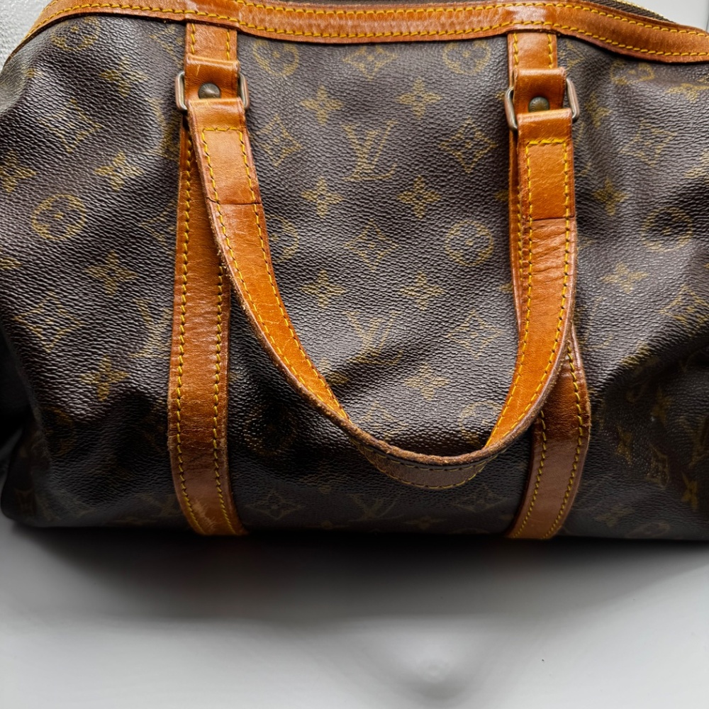 This is a Louis Vuitton Monogram Sac Souple travel bag.